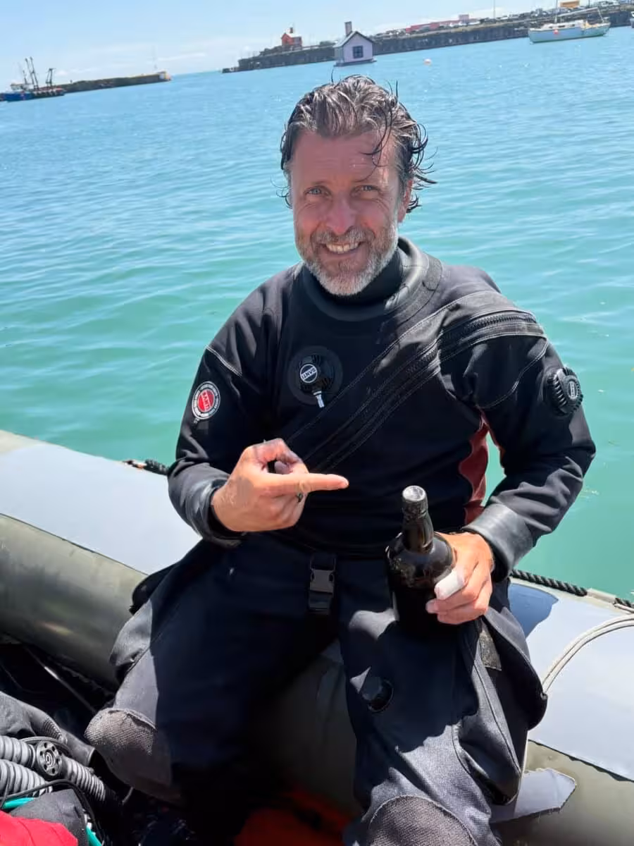 Stefan Panis Holding The 162 Year Old Guinness Bottle Recovered From A Shipwreck Off Dover, England.