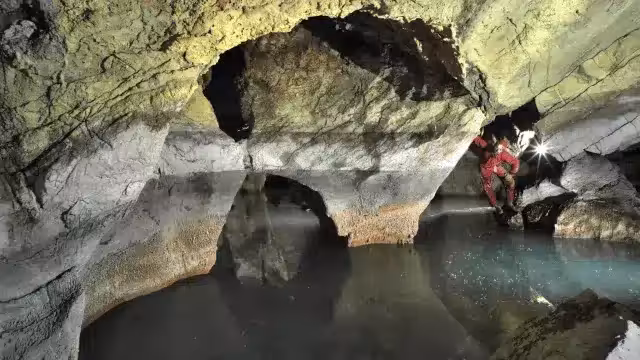 Researchers Explore The Warm Mineral Waters Of Lake Neuron Inside Atmos Cave In Southern Albania.