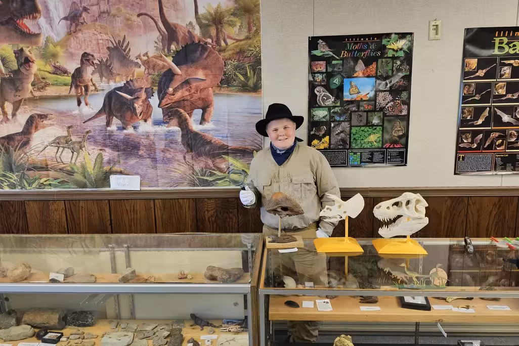 Boy in front of museum display cases