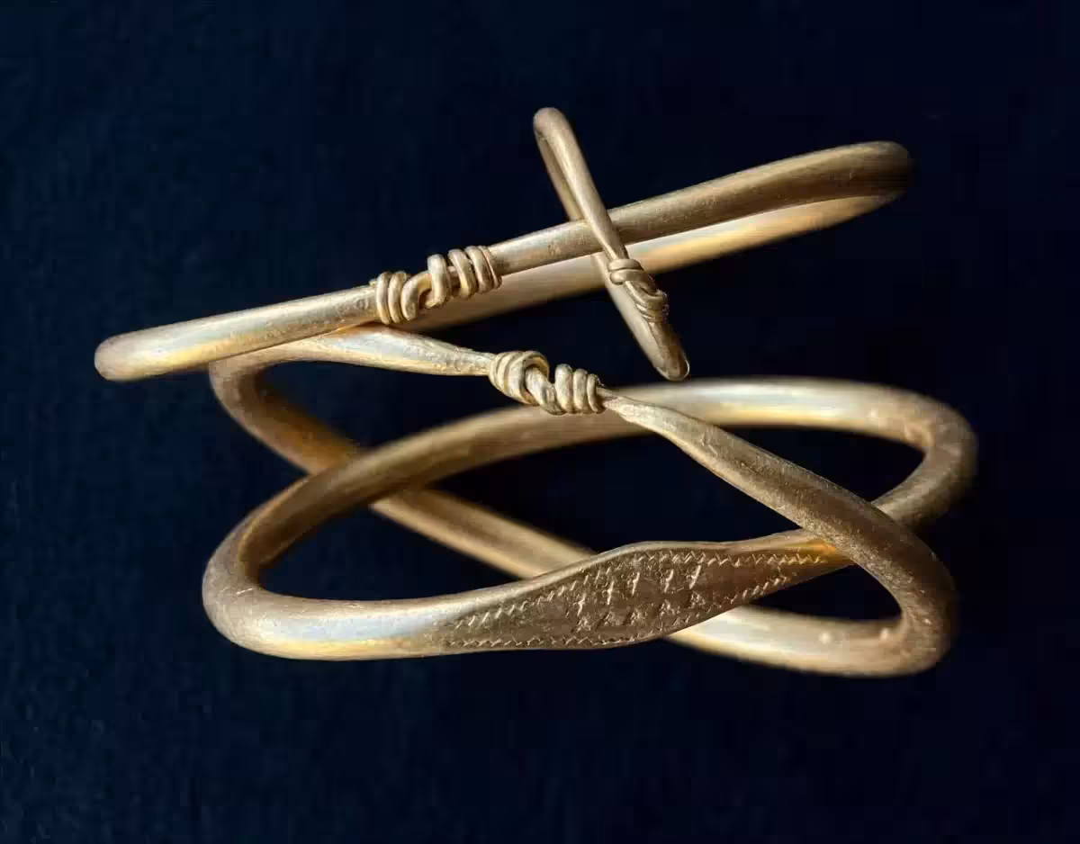 Three Of The Viking Gold Arm Rings Are Smooth, While One Features Distinctive Zigzag And Triangle Decorations.