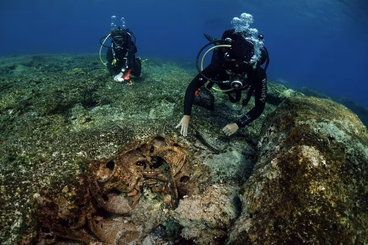 Underwater Archaeologists Examine Corroded Metal Remains