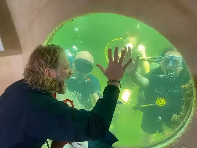 Joseph Dituri Communicates With Divers Outside The Underwater Habitat During His 100 Day Ocean Experiment Off The Coast Of Florida.