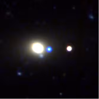 Telescope image with orbs of light in white, blue, and light yellow.