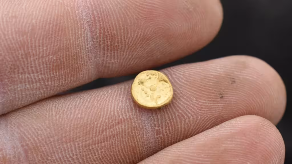 A Close Up View Of A Tiny Gold Coin Discovered In An Iron Age Treasure Hoard In Bohemia.