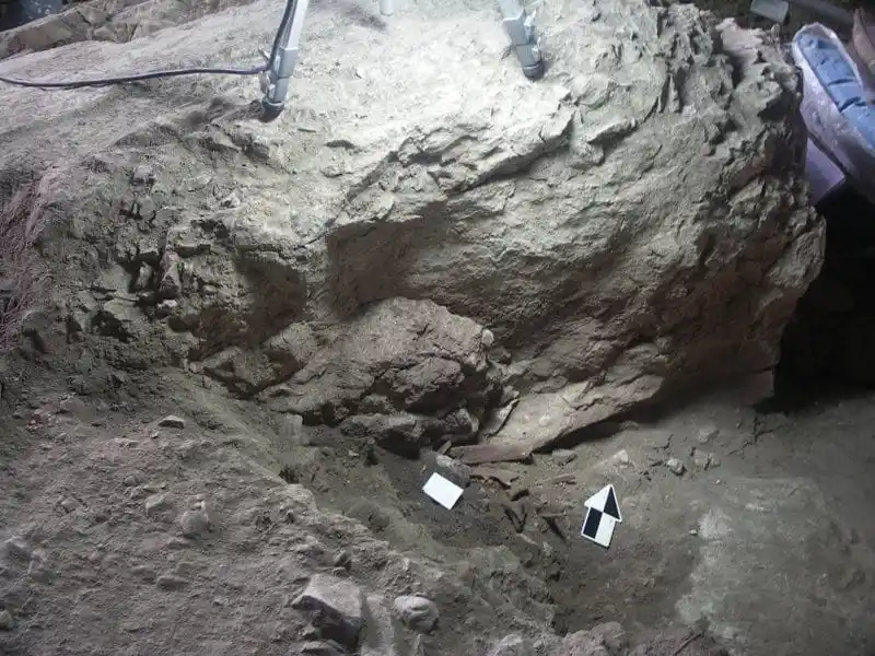 The Burial Site Of The Red Lady Of El Mirón, Marked By Red Ochre And Preserved Skeletal Remains.