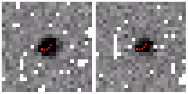 Two Hubble Space Telescope images capture the distant trans-Neptunian object 2015 GK56, with red markers tracing its predicted movement during each 20-minute exposure.