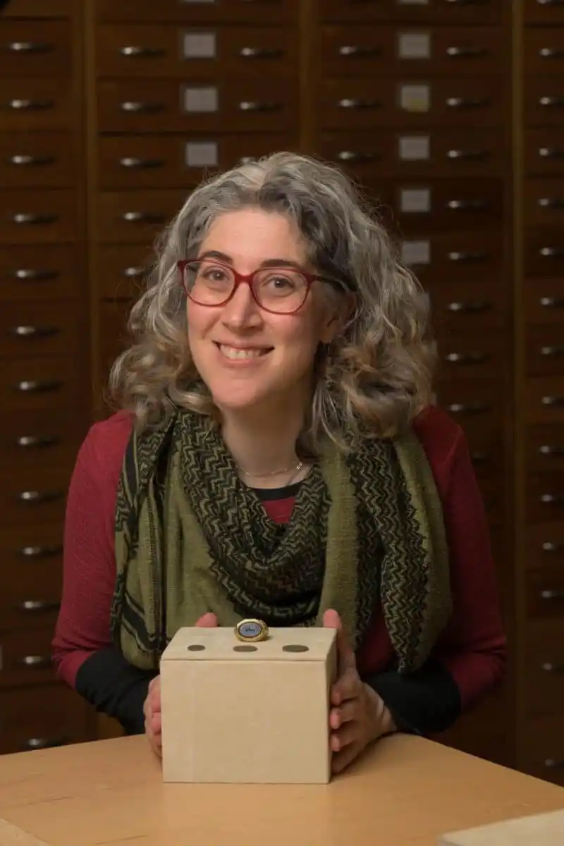 Senior Curator Amal Khreisheh Displays The Ilminster Ring Alongside Coins Discovered In The Same Roman Hoard.