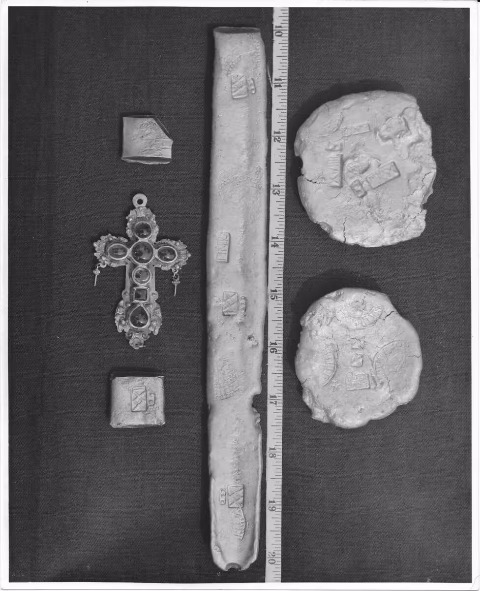 Artifacts recovered from the San Pedro shipwreck, including silver bars, coins, and religious objects discovered among the sunken treasure.