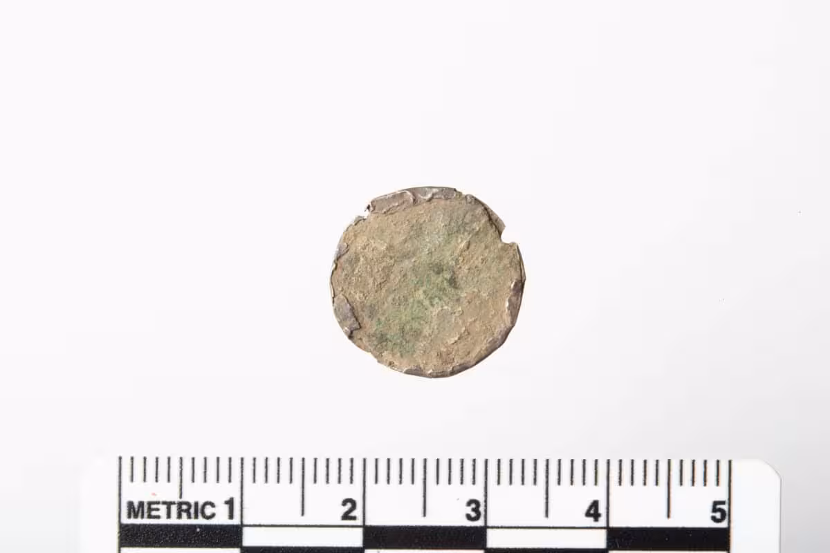 The Coin's Exposed Face, Showing A Cross Superimposed On A Cross Shaped Motif.