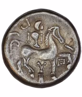 An Ancient Celtic Silver Coin Featuring A Horse Surrounded By Symbolic Designs.