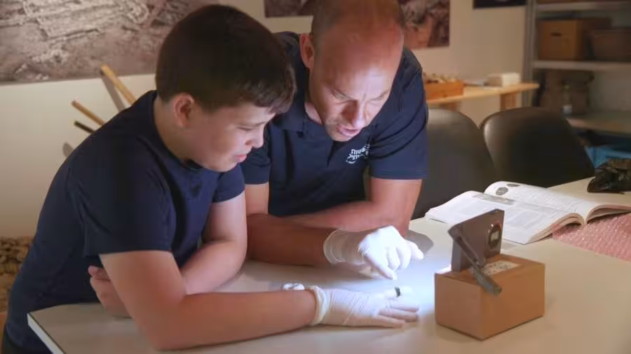 Yair Whiteson And An Israel Antiquities Authority Expert Inspect The 1,800 Year Old Ring.