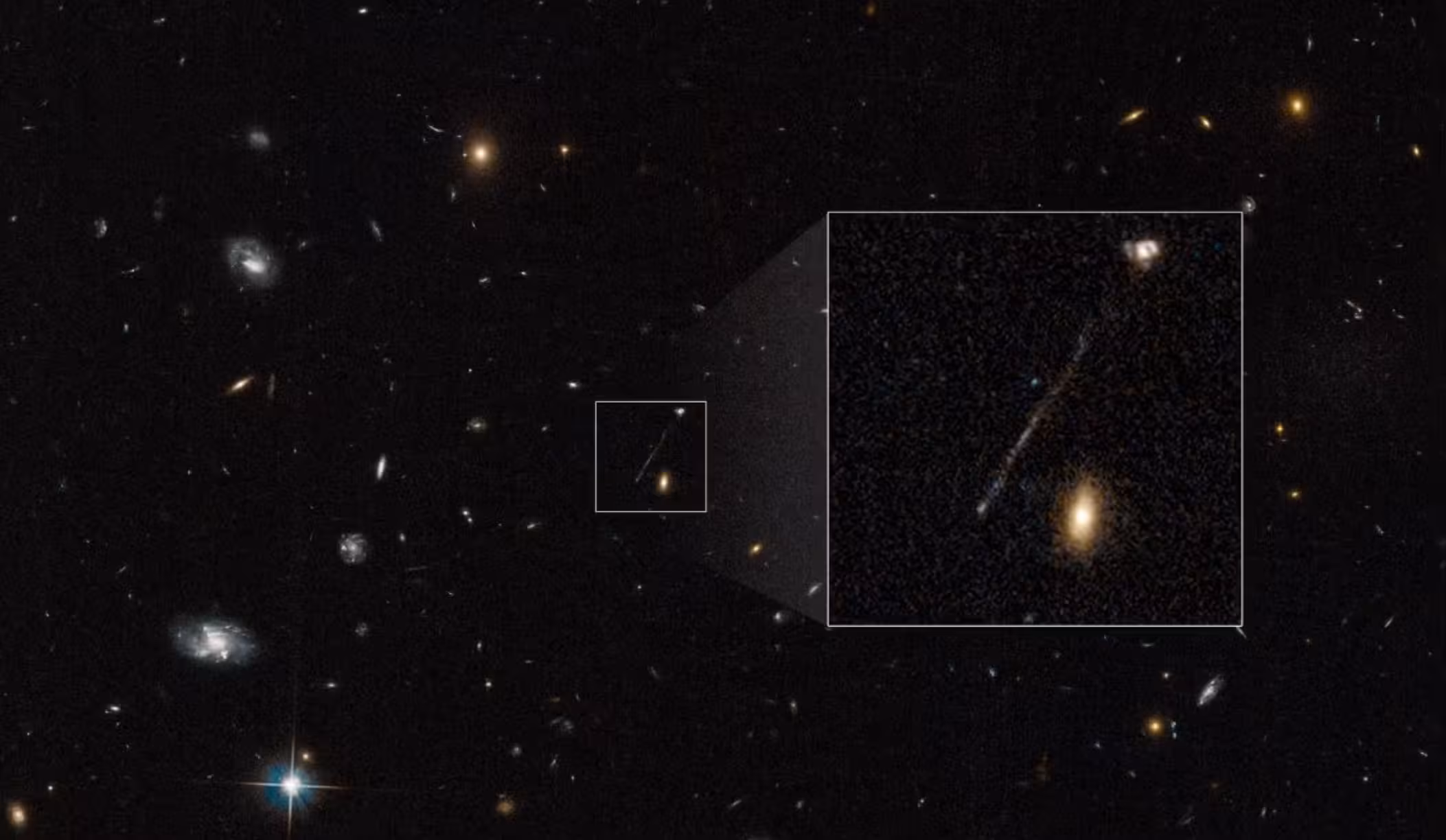 Scientists initially blamed the streak on a Hubble imaging glitch. Follow-up observations instead revealed a 200,000-light-year trail of young blue stars stretching toward the galaxy at upper right.