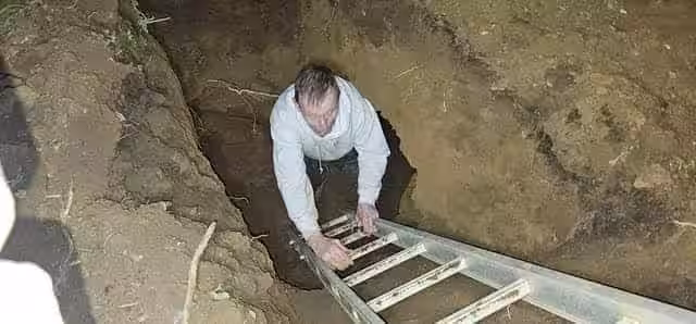 Researcher Carefully Ascends A Ladder After Venturing Into A Newly Discovered Underground Passage In Bloxham.
