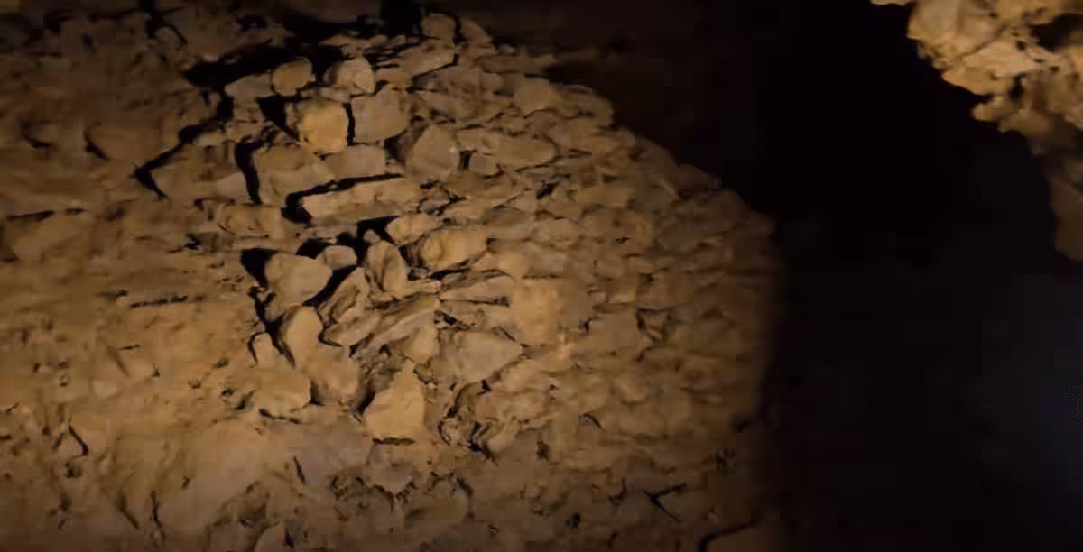 Inside The Tunnel, Three Piles Of Stones Are Neatly Arranged, But Their Function Is Still Unclear.