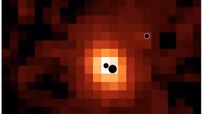 Three Black Holes Mapped Inside J0148 4214.