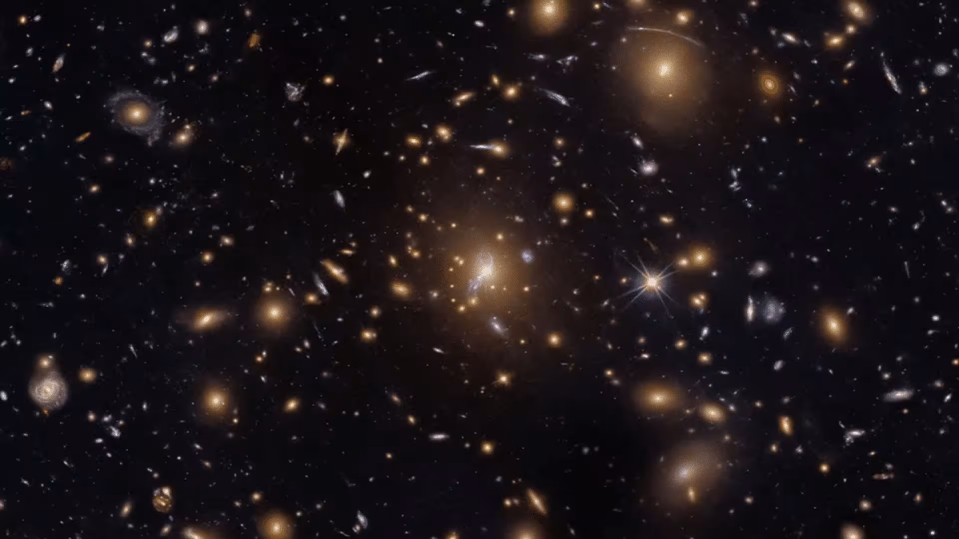 Hubble Captures A Cosmic Swarm That Is Bending Light Across The Universe Scaled