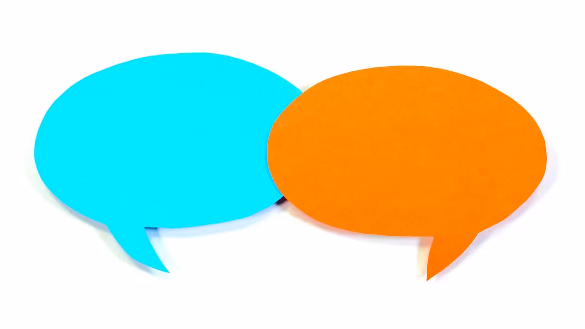 Two speech bubbles cut out of construction paper on a white background.