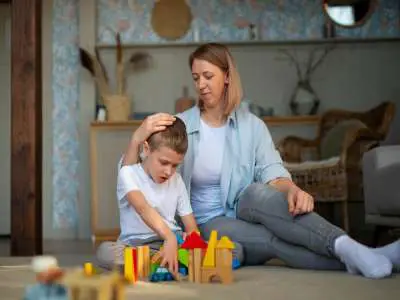 Free photo mother playing with her autistic son using toys.