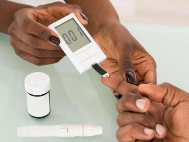 Close-up Of Hands Using Lancet On Finger Testing For Diabetes