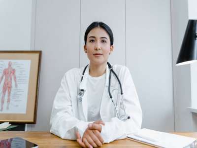 Woman in White Scrub Suit Wearing Black Stethoscope