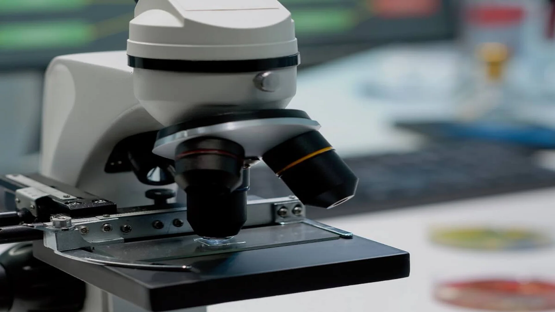 Close up of glass lens microscope on laboratory desk.