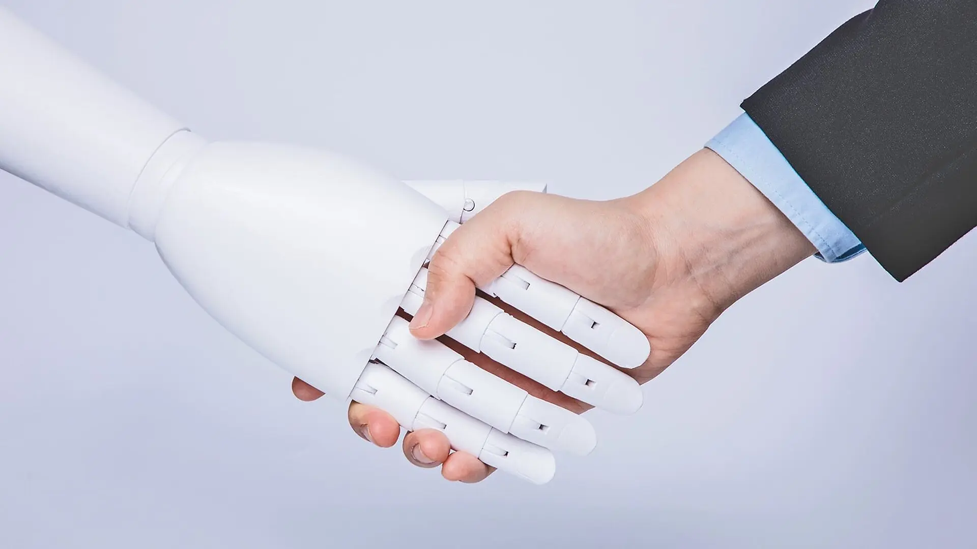 A person shakes a robot hand.