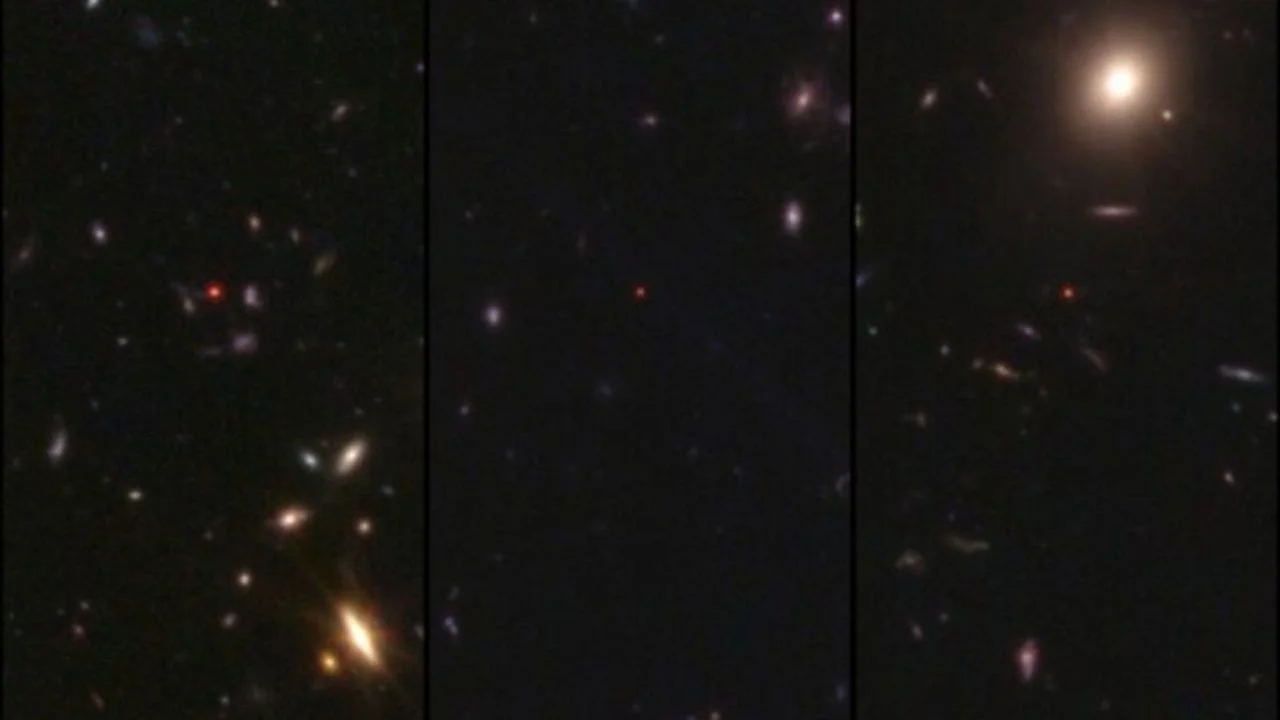A deep space image showing the glow of stars and galaxies against a black background along with little red dots throughout the image.