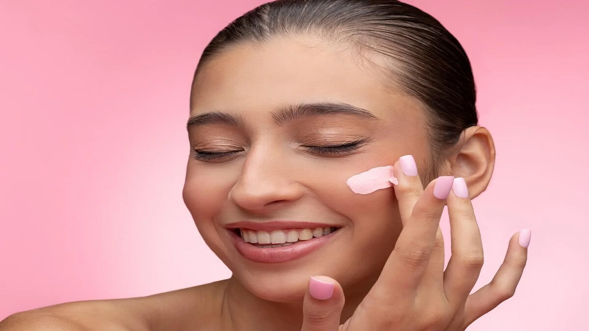 Woman Applying Cream on Face