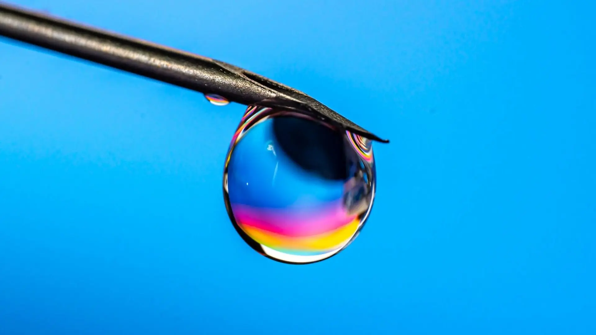 Colorful Drop Of Liquid On Needle Tip