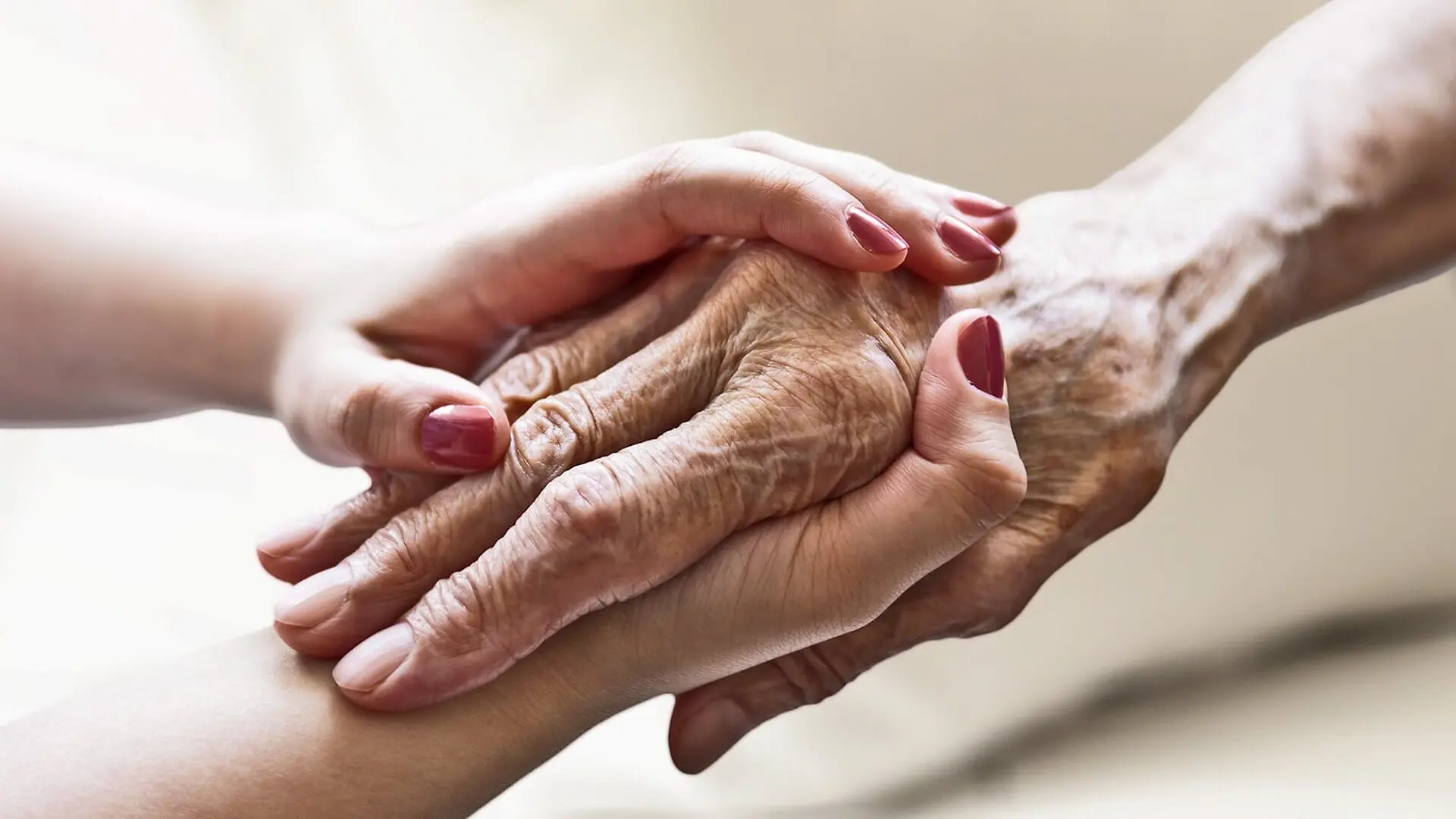 A young person holds an older person