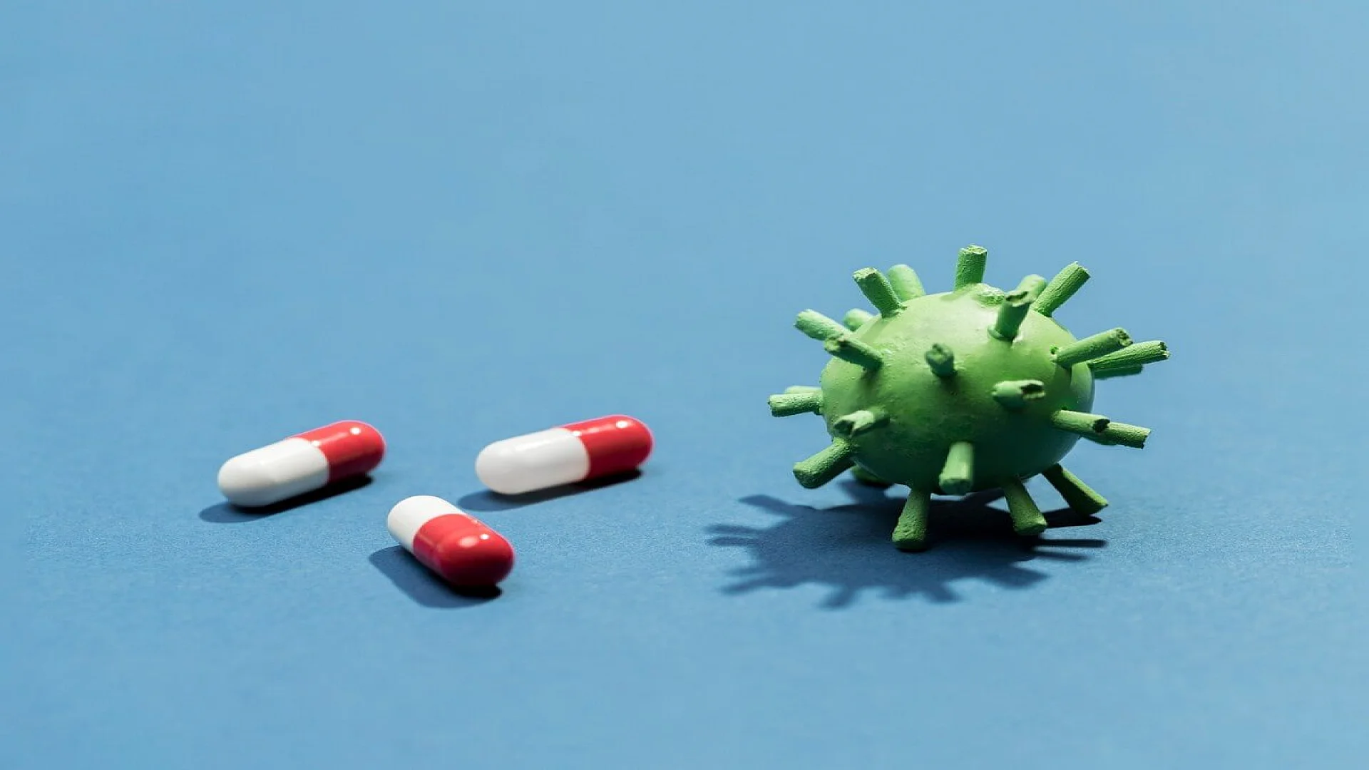 High angle pills beside virus bacteria.