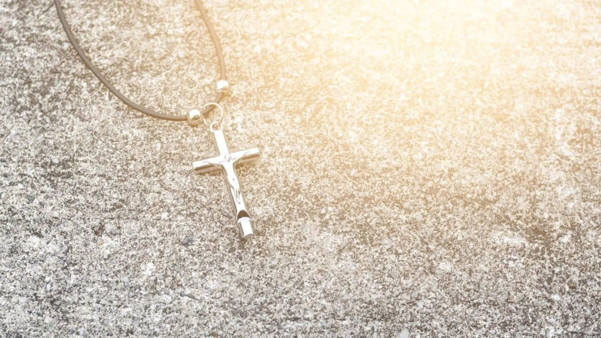 Necklace With A Cross On A Gray Background Scaled