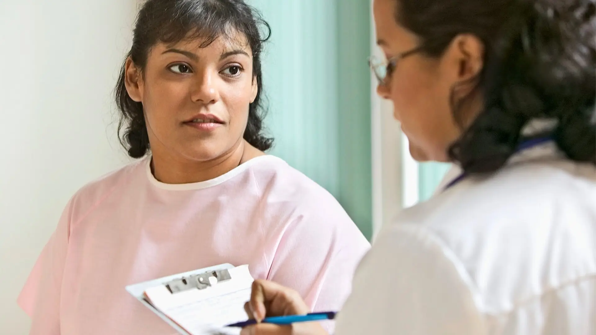A woman speaks to her doctor.