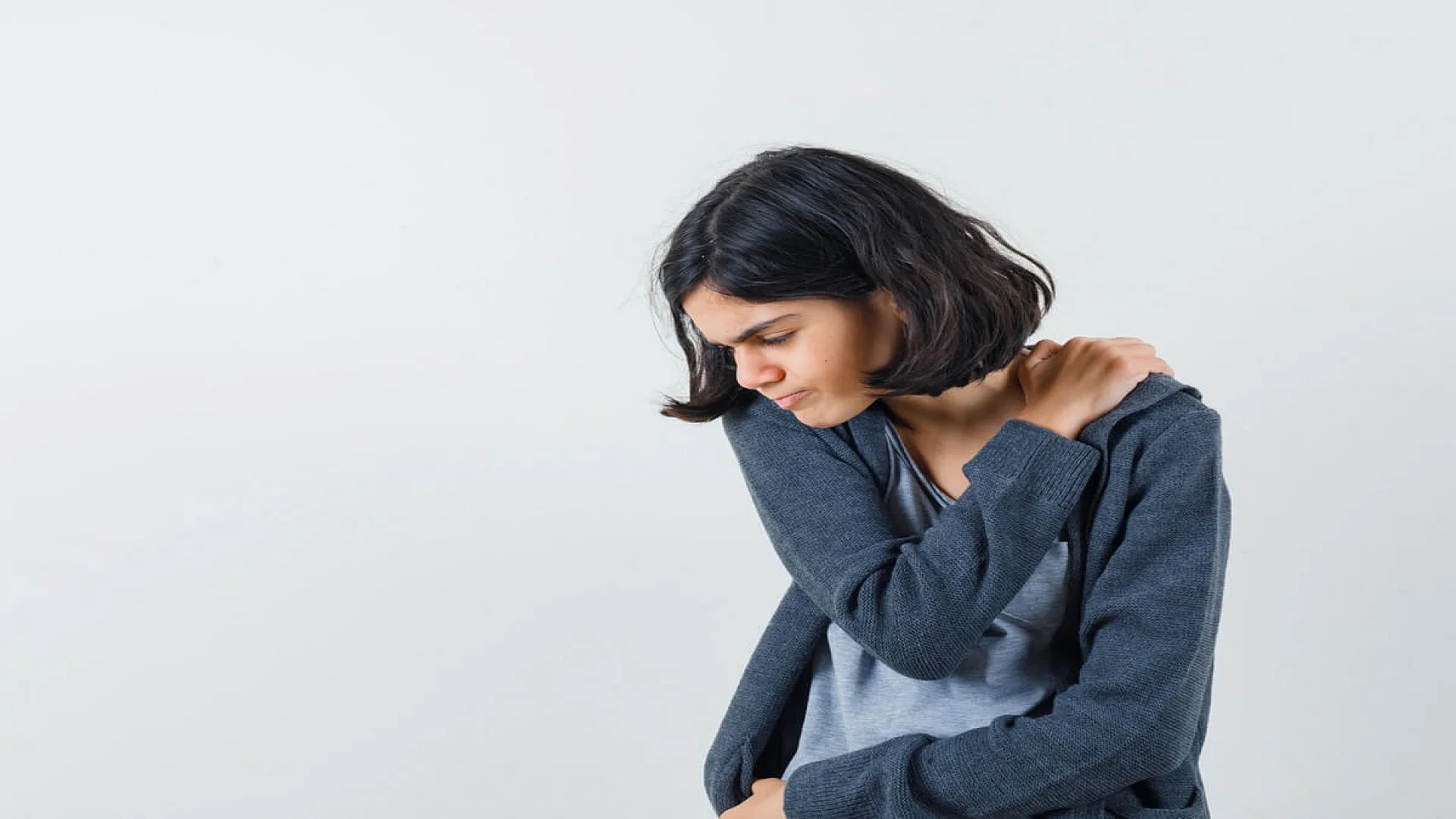 Young Girl Having Shoulder Pain and Looking Exhausted