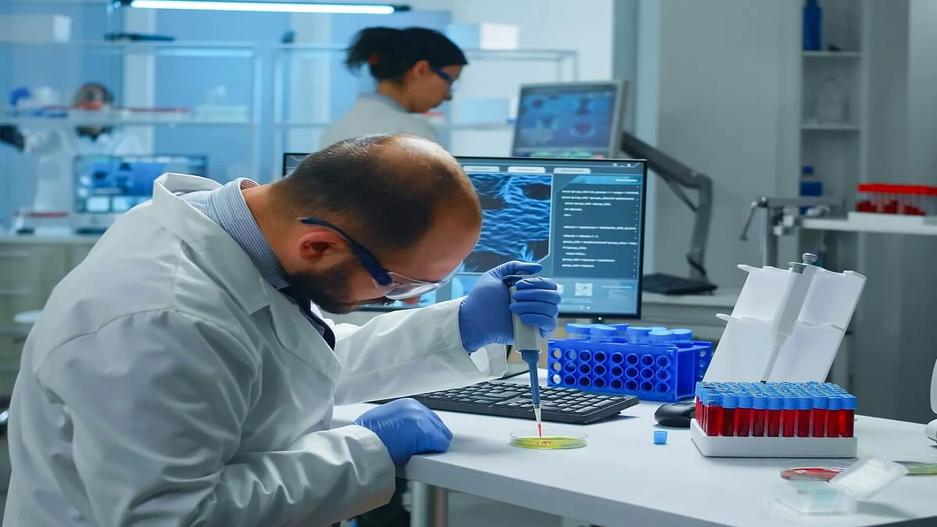 Scientist Transferring Blood Sample from Test Tube to Petri Dish
