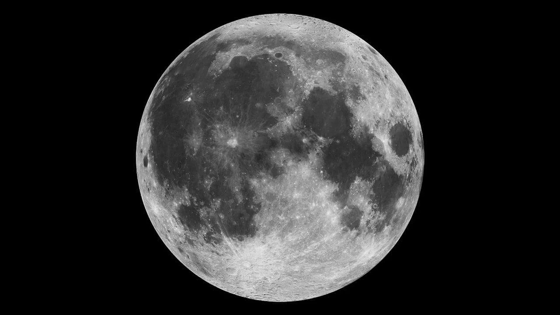 A detailed grayscale composite of the full moon showing numerous craters and dark volcanic plains against a black background.