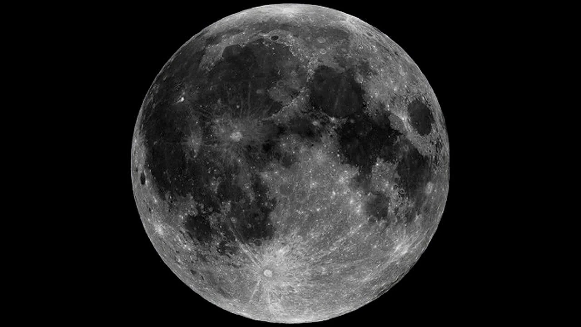 A high-contrast, full-disk photograph of the Moon against a black background, highlighting the dark basaltic plains and lighter, heavily cratered highland regions.
