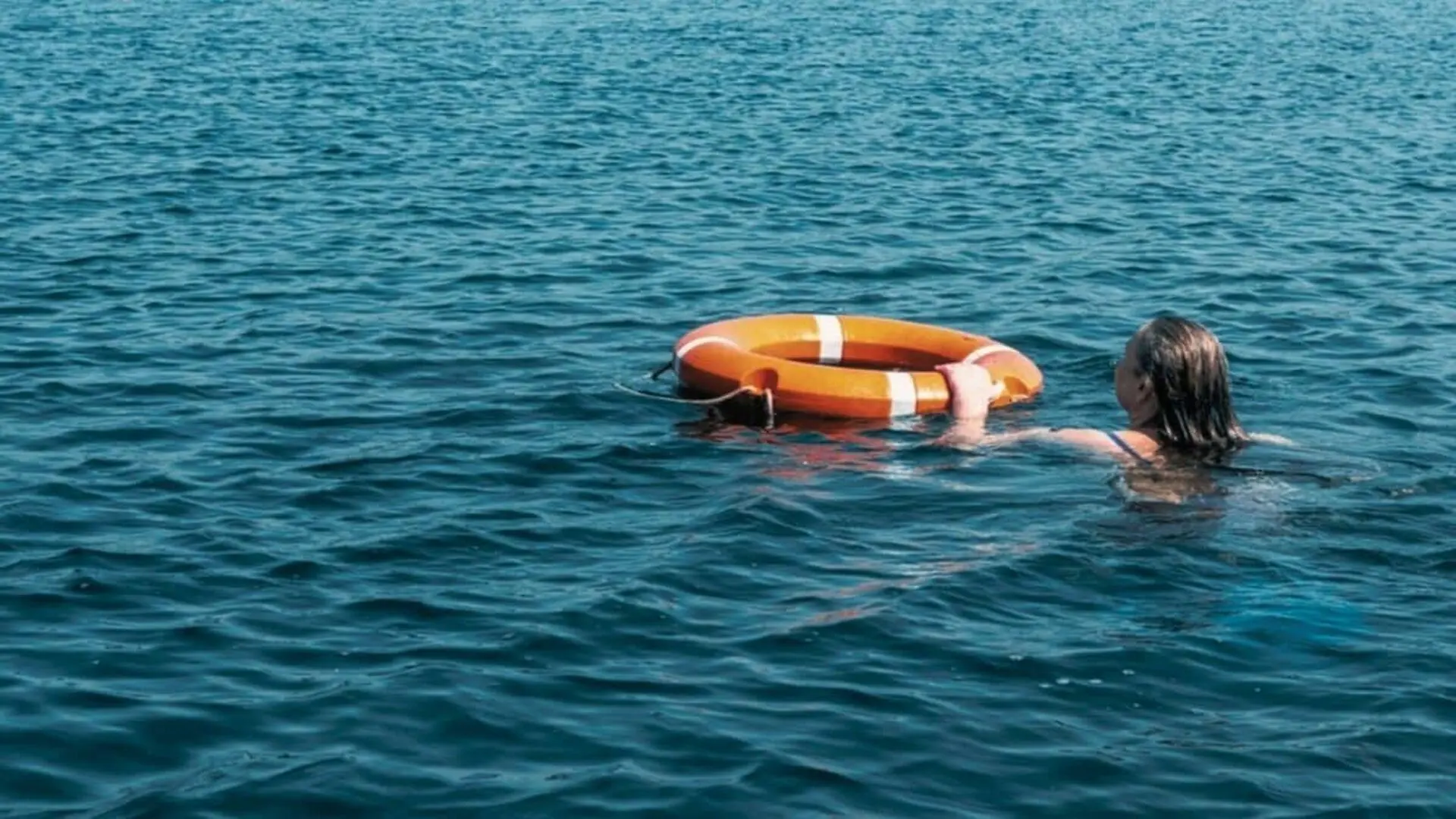 A Person In The Water Is Given A Lifebuoy To Help Them Scaled