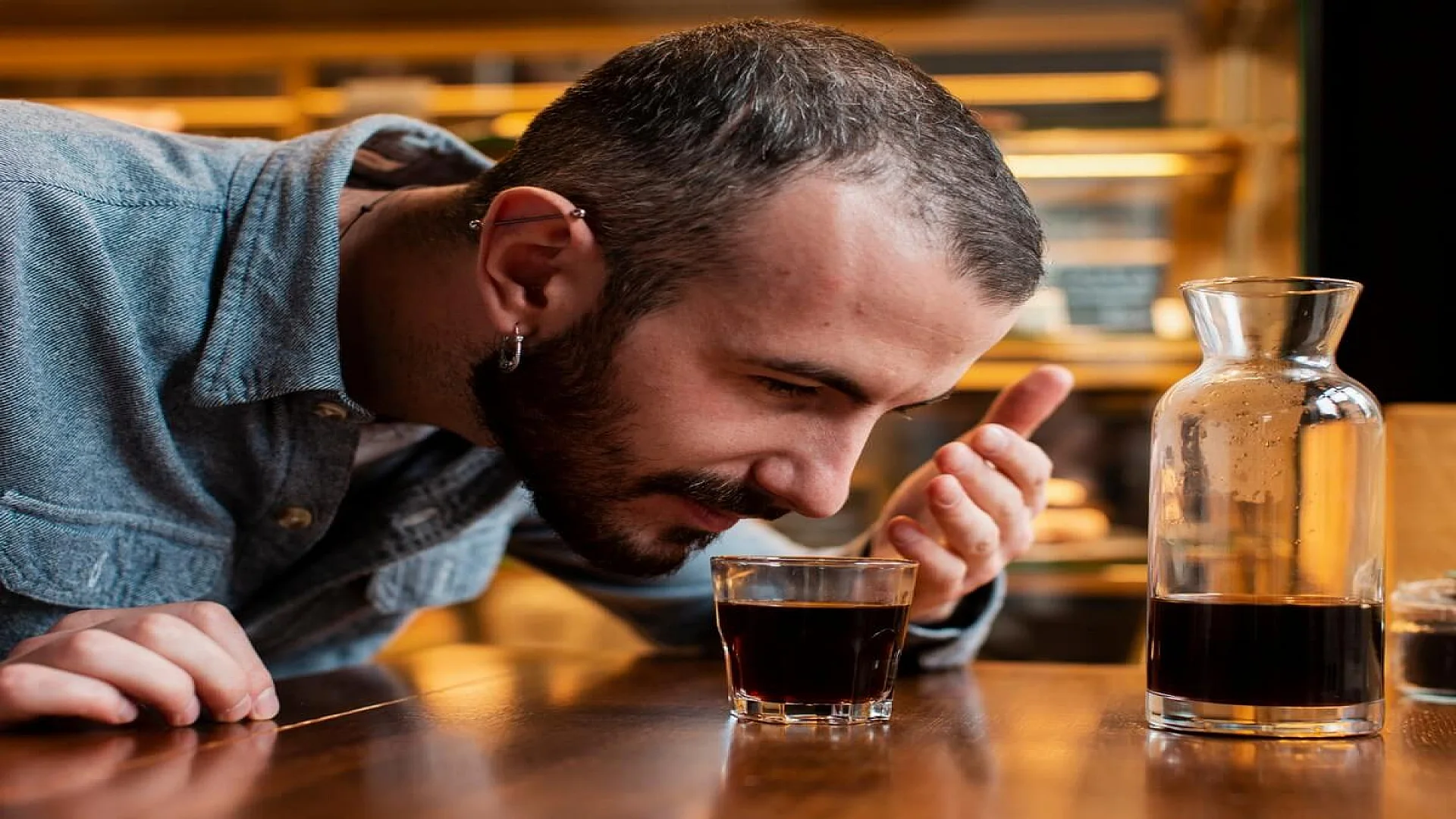 Man Smelling Cup of Coffee