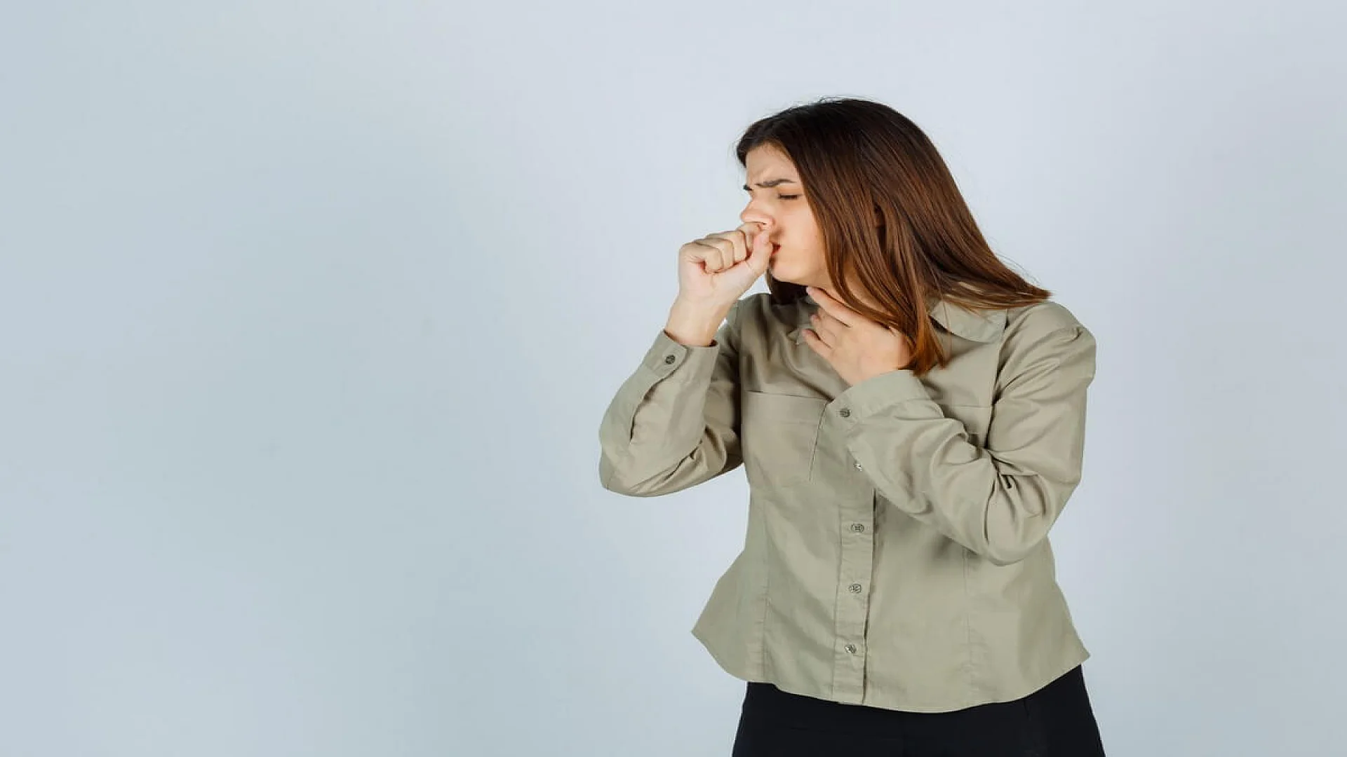 Young lady in shirt, skirt suffering from cough and looking sick, front view.