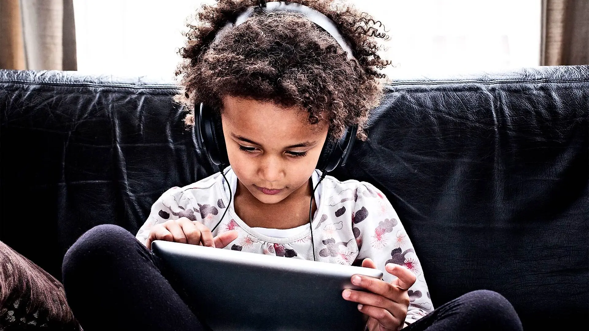 A young girl using a tablet computer.