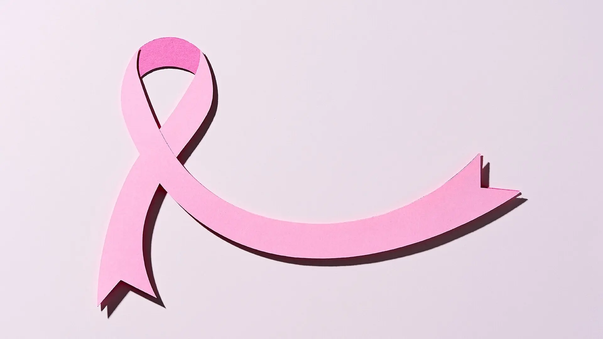 A paper cutout of a pink ribbon.
