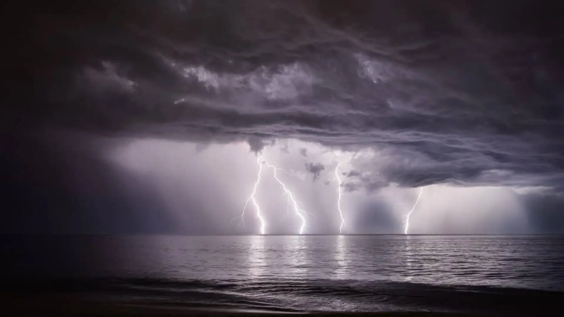 Lightning Strikes The Ocean During A Dramatic Storm Off The Coast Of North Carolinas Outer Banks Scaled