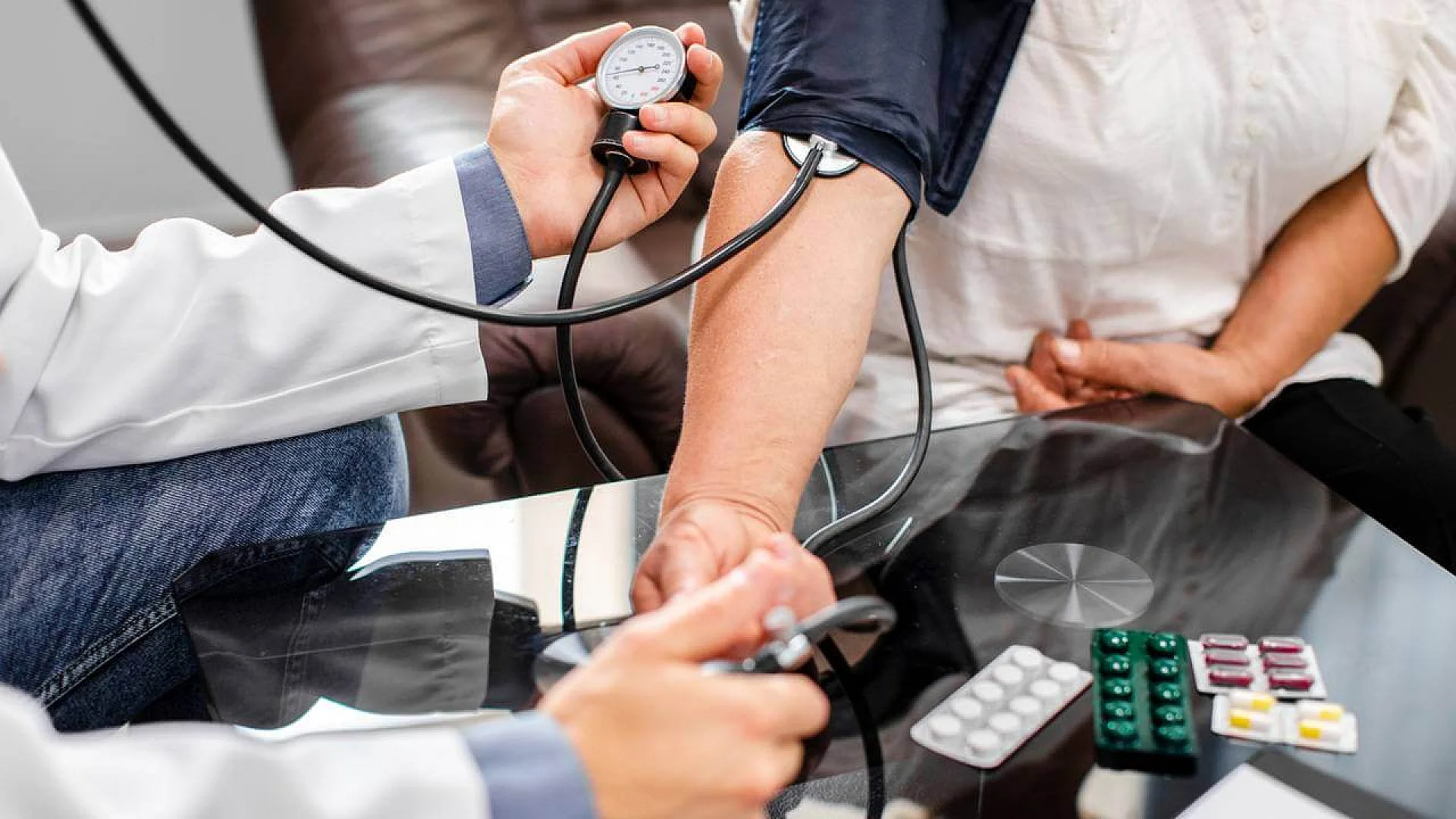 Male doctor measuring blood pressure