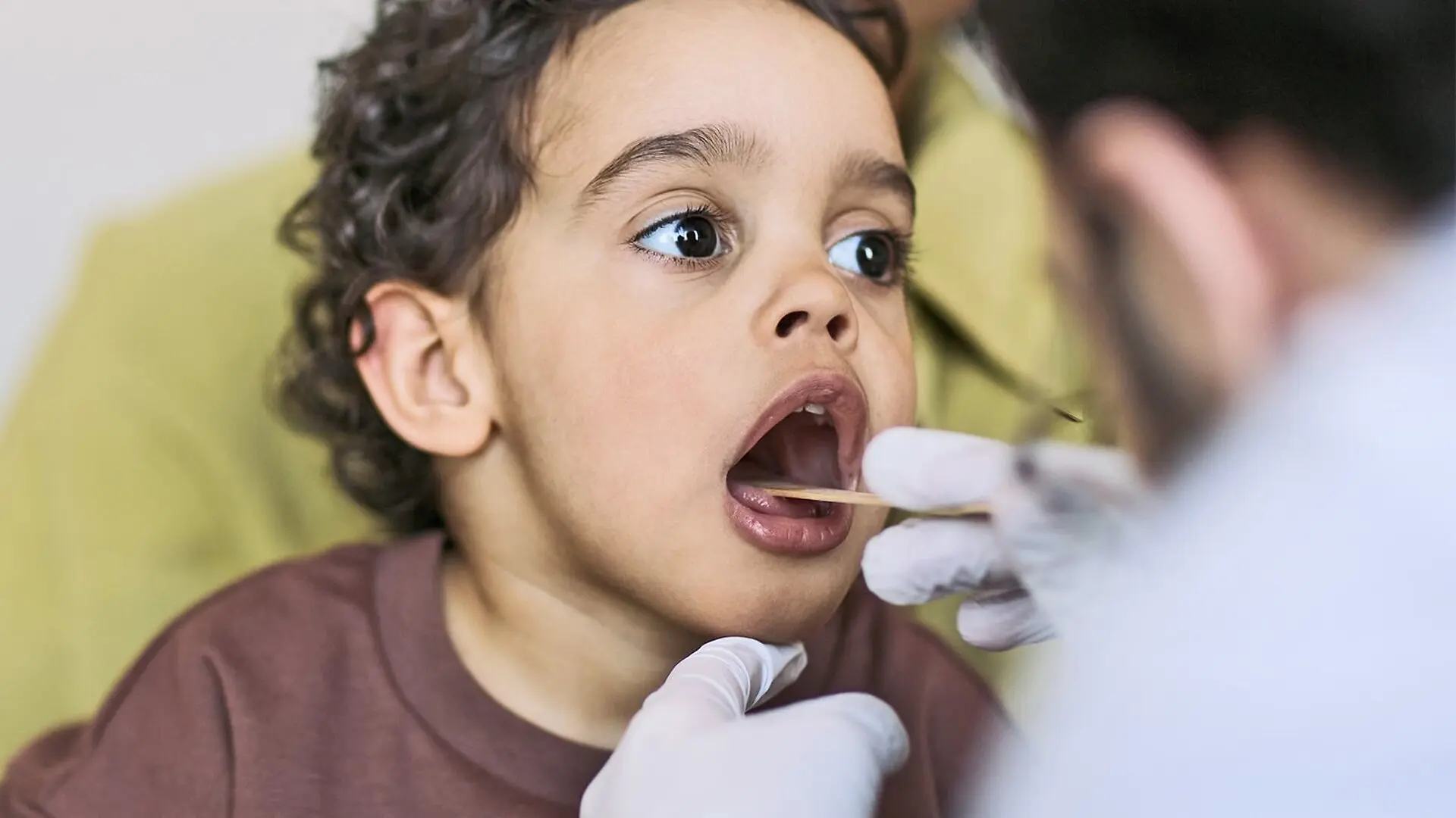 A doctor checks a young boy