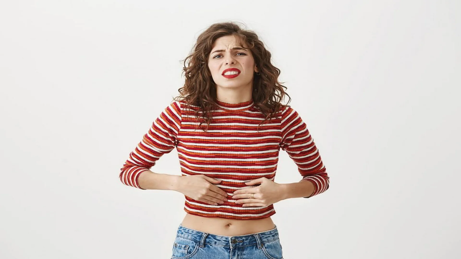 Free photo woman got food poisoning, feeling unwell, touching stomach and grimacing from pain.