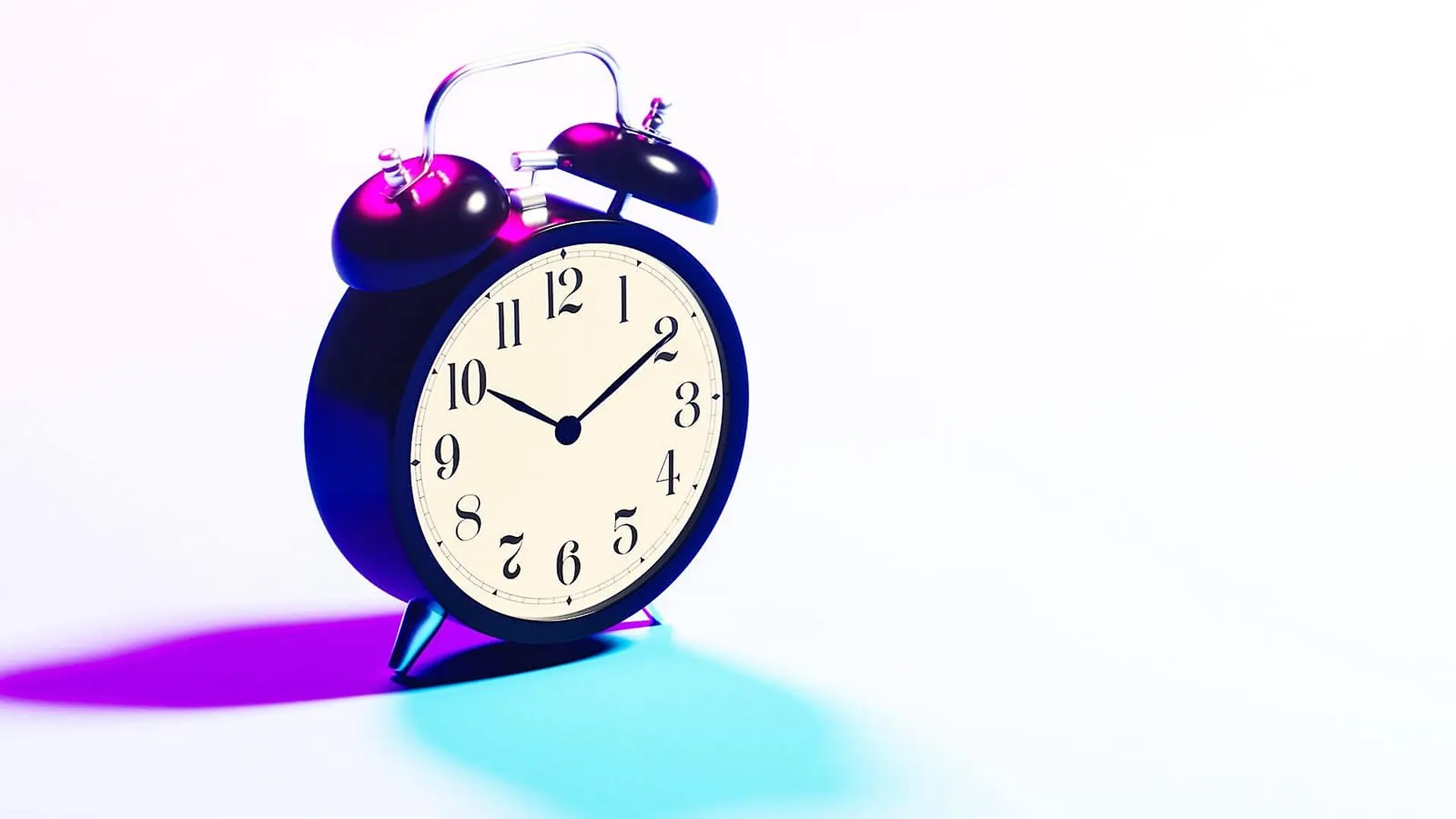 A retro alarm clock has purple and blue light shining on it.