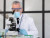 Free photo old scientist working with microscope.