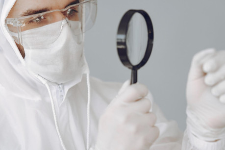 Forensic Scientist Investigating Blood Spatter Shapes