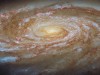 Hubble Reveals a Giant Spiral Galaxy Racing Toward a Dramatic Fate